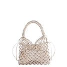 Adriana Castro LA RED mini leather top handle bag in gold with sleek design and compact shape.