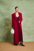 White Plan Scarlet tailored coat hanging on a rack, showcasing its elegant design and classic tailored fit.