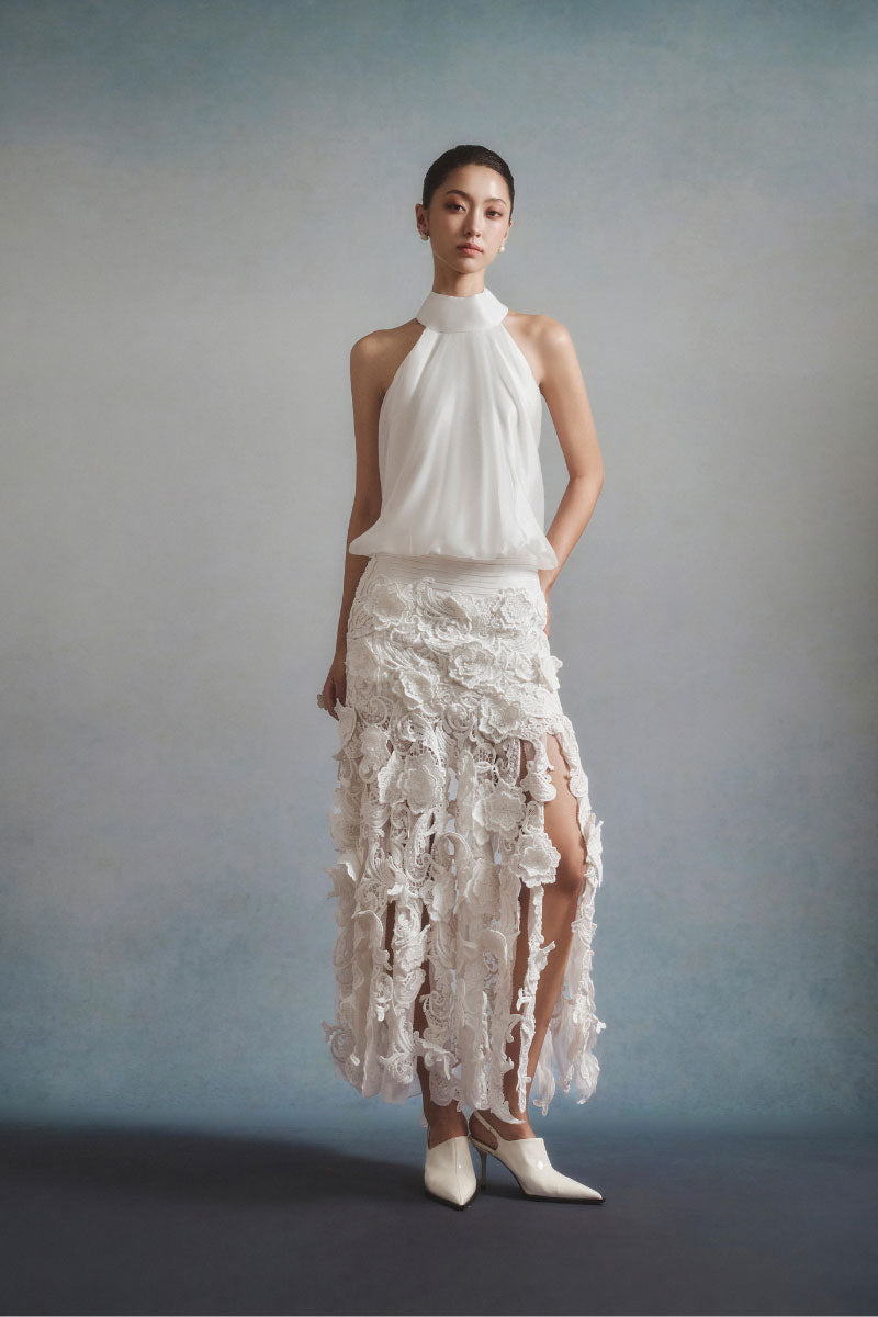 White Plan Flora halter midi dress displayed on a hanger, featuring a flowy fabric and floral pattern.