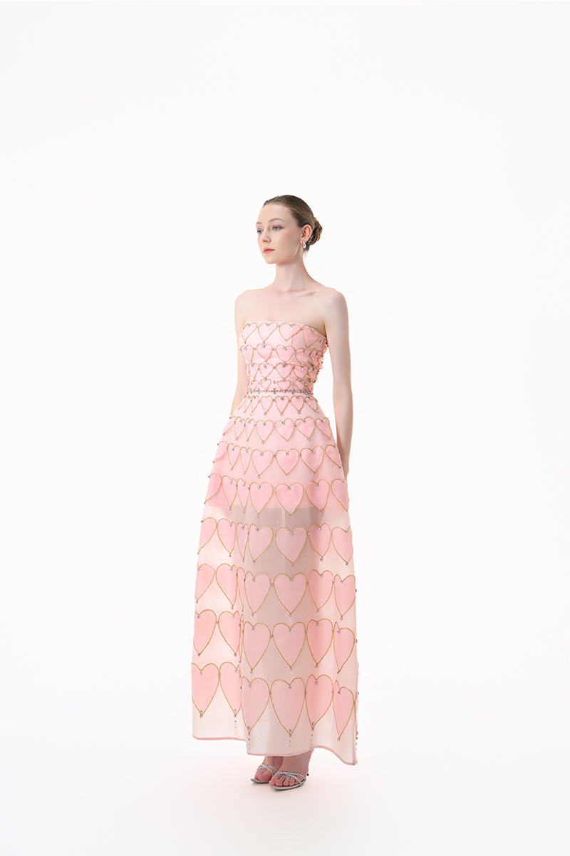 Blush pink embellished heart motif gown by Happy Clothing featuring intricate embroidery and flowing fabric.