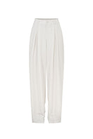 White tapered leg trousers by Valenciani, featuring a sleek fit and smooth fabric, displayed on a mannequin.