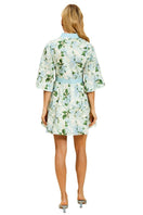 Mestiza New York Carmen mini dress in Quatrefoil Garden print with a fitted silhouette and short sleeves, displayed on a hanger.