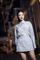 FELICIA blue shiny silk floral co-ord set with matching shirt and skirt from 21Six, featuring a glossy fabric and vibrant floral pattern.