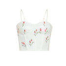 Estefania lovely ivory tulip corset top displayed on a model, featuring a fitted design with floral-inspired tulip detailing.