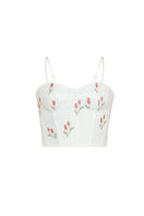 Estefania lovely ivory tulip corset top displayed on a model, featuring a fitted design with floral-inspired tulip detailing.