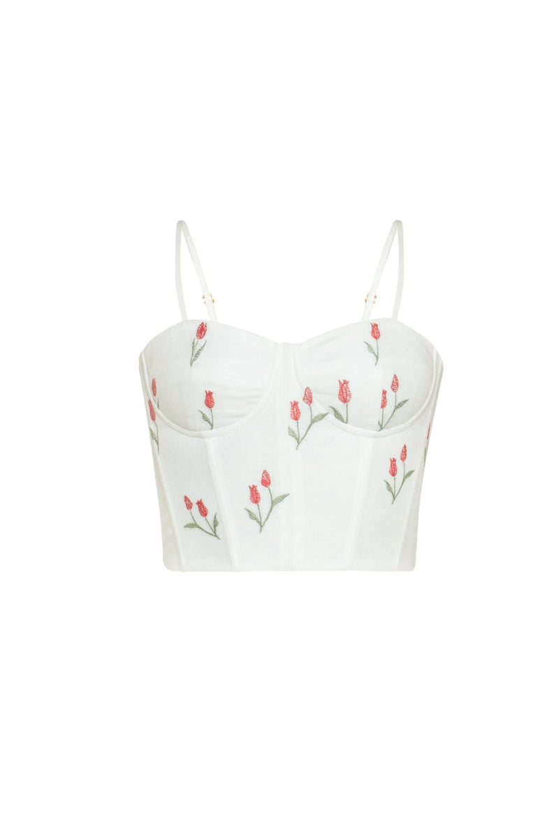 Estefania lovely ivory tulip corset top displayed on a model, featuring a fitted design with floral-inspired tulip detailing.