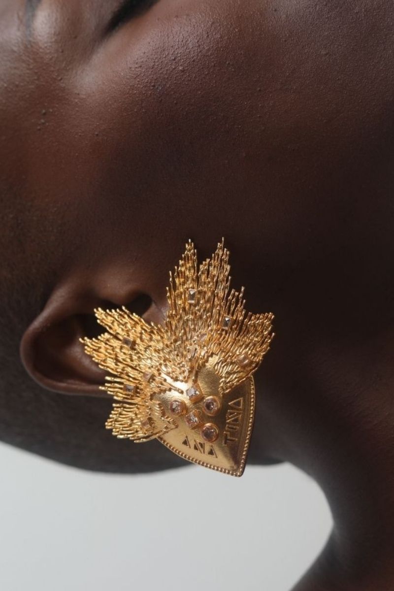 Anatina Amaryllis earrings featuring delicate floral design with gold-tone accents, showcasing elegant jewelry craftsmanship.