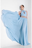 Blue embellished chiffon gown by Monika Dimova featuring intricate beadwork and flowing fabric for elegant evening wear.