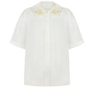 Elegant milk silk shirt with ornament details by DELEGAN, showcasing a stylish and comfortable design.