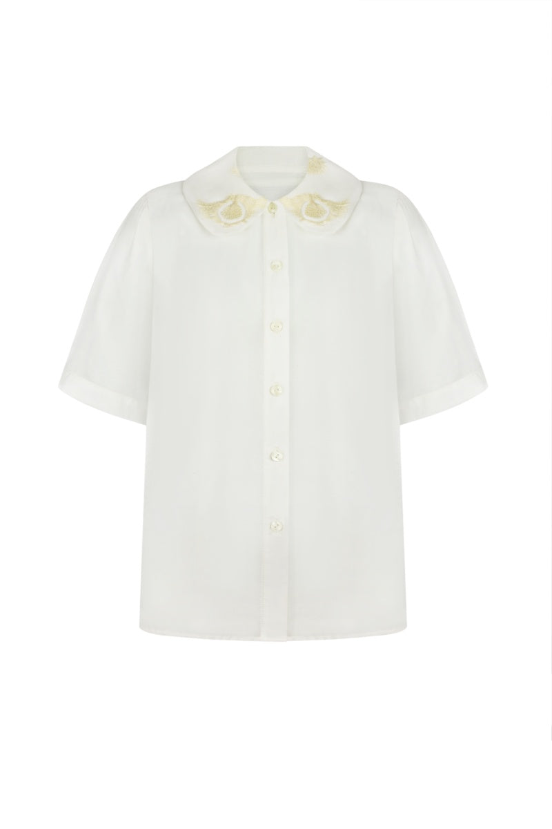 Elegant milk silk shirt with ornament details by DELEGAN, showcasing a stylish and comfortable design.