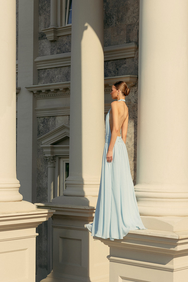 Powder blue embroidered gown by Monika Dimova, featuring intricate embroidery and flowing fabric, perfect for elegant occasions.