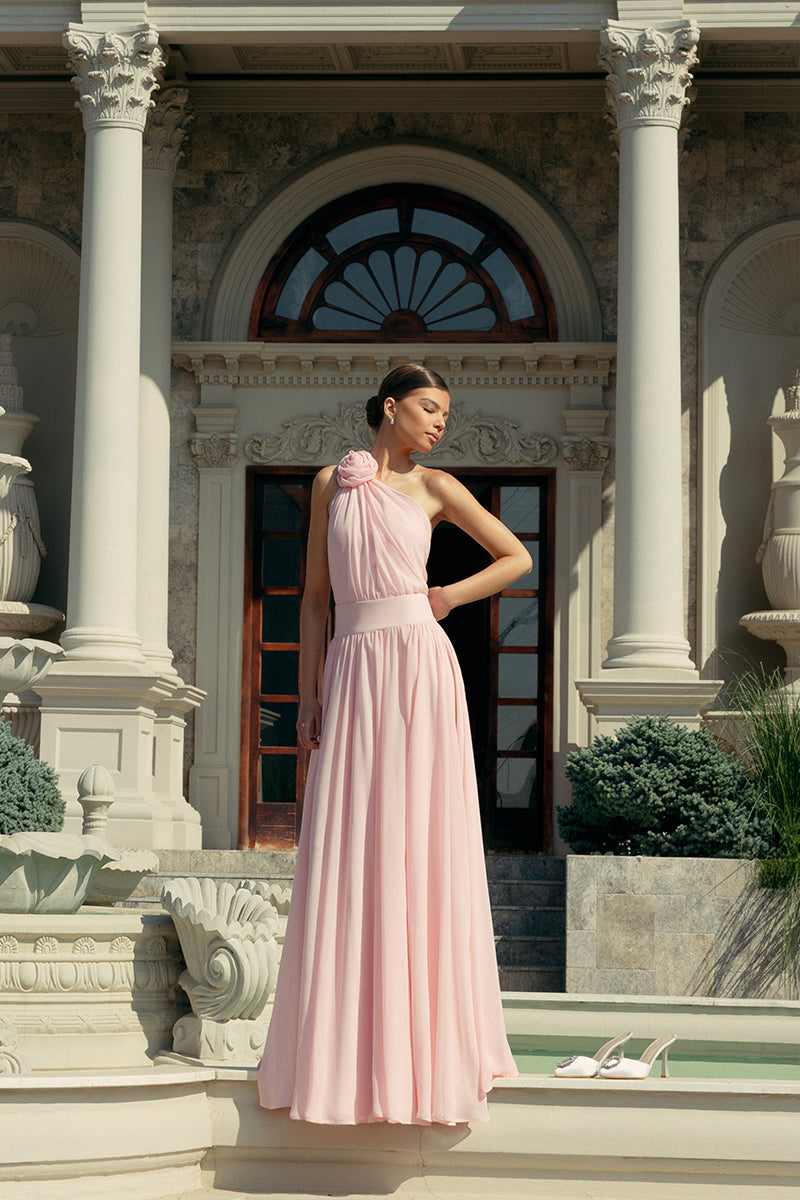 Elegant blush floral gown by Monika Dimova featuring intricate floral patterns and flowing fabric.