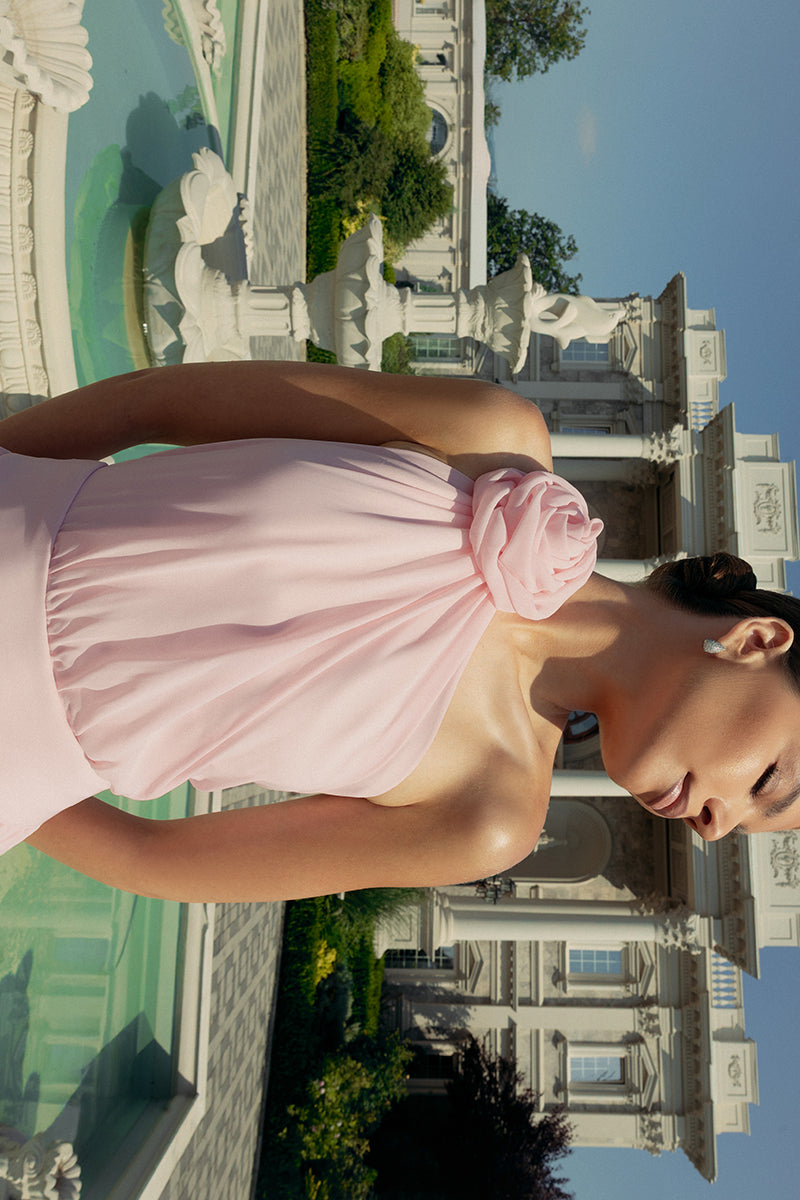 Elegant blush floral gown by Monika Dimova featuring delicate floral patterns and flowing fabric.