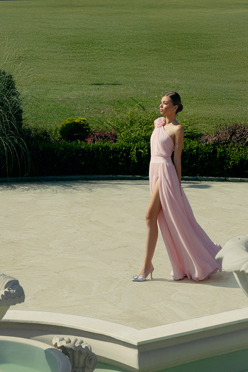 Elegant blush floral gown by Monika Dimova featuring delicate floral patterns and flowing fabric, perfect for formal occasions.