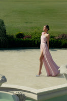Elegant blush floral gown by Monika Dimova featuring delicate floral patterns and flowing fabric, perfect for formal occasions.