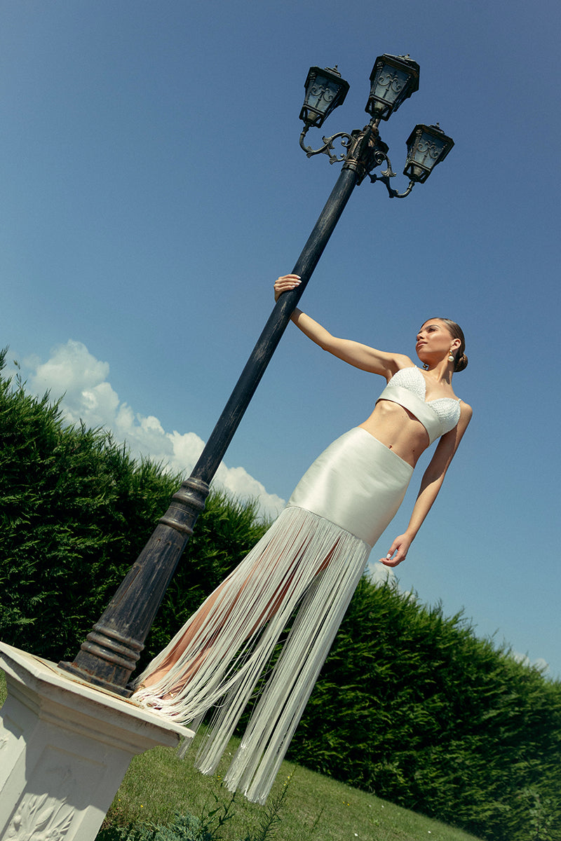 Ivory fringe two-piece co-ords set by Monika Dimova, featuring a stylish top and matching skirt with fringe details.