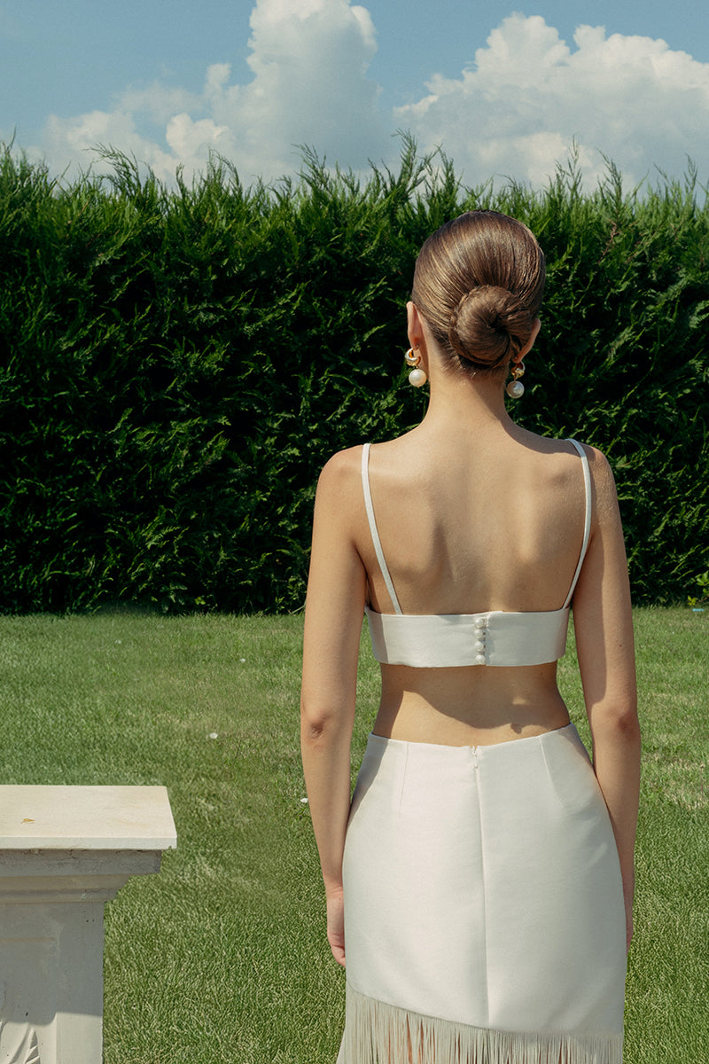 Ivory crystal bralette top by Monika Dimova with delicate crystal embellishments and soft fabric, displayed on a white background.