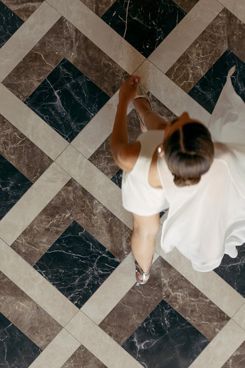 White embellished mini dress by Monika Dimova, featuring intricate details and a stylish, fitted silhouette.