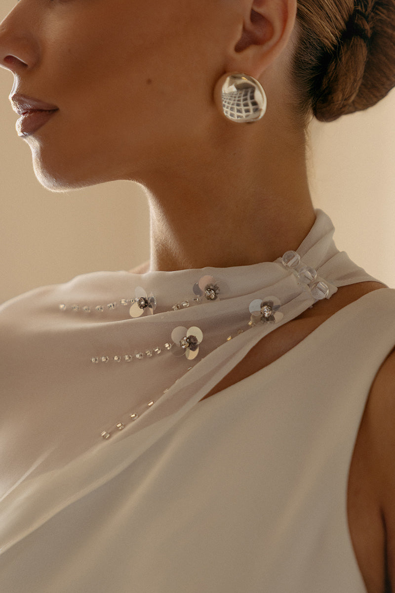 White embellished cape mini dress by Monika Dimova, featuring intricate detailing and a stylish, modern design.