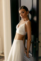 White soft crepe maxi skirt by Monika Dimova, flowing and elegant, shown draped on a model with a high waist and full length.