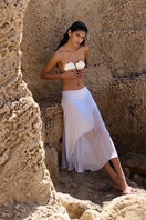 IKINITA Nausica midi skirt in lilac fabric, showcasing its flowy design and elegant length in a stylish fashion shot.