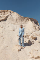 Blue IKINITA Sun Pants laid flat, showing relaxed fit and lightweight fabric, perfect for casual wear and outdoor activities.