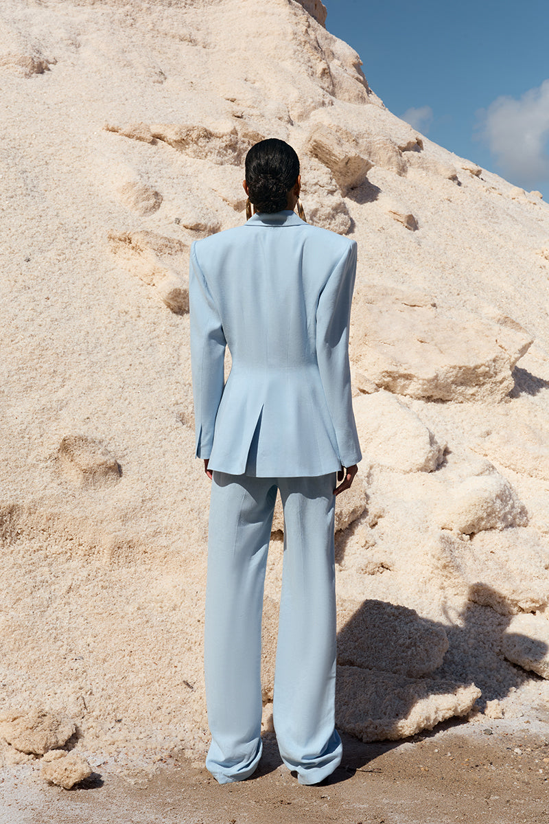 IKINITA THE SUN PANTS in blue, casual pants with a relaxed fit, shown on a model against a neutral background.