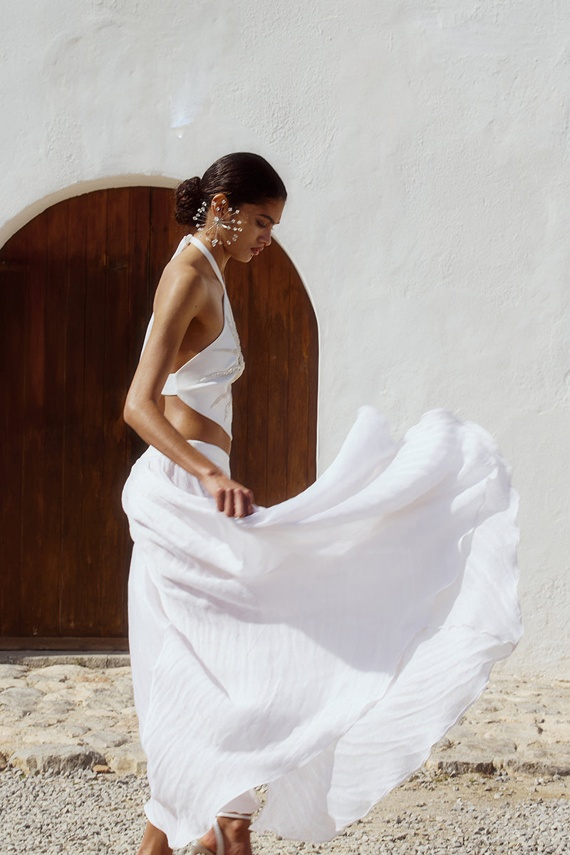 White Ikinita Innocent Top, stylish women's blouse with a relaxed fit, featuring a soft fabric and modern design.