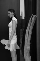 White mini sundress by IKINITA, featuring a lightweight, flowy design perfect for summer or casual outings.