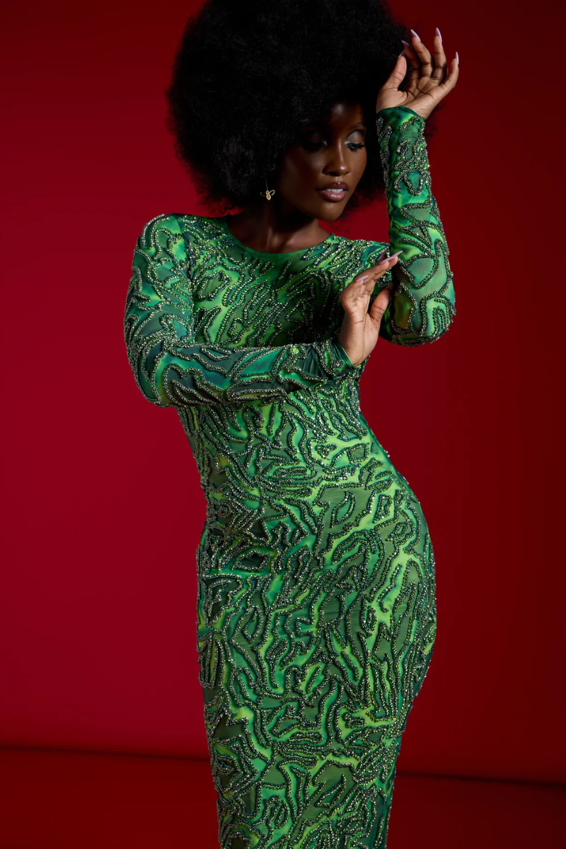 Green ZUWA maxi dress by Onalaja, featuring a flowing silhouette and elegant design, displayed on a hanger.