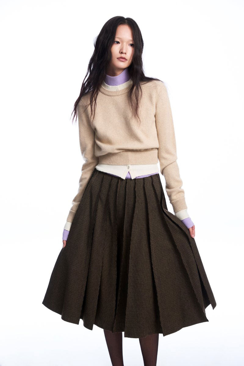 Beige layered cashmere sweater by Chictopia, showing the soft, cozy knit fabric and stylish layered design.