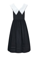 Black Sydney dress by Chictopia, elegant midi dress with a fitted silhouette, shown on a model against a neutral background.