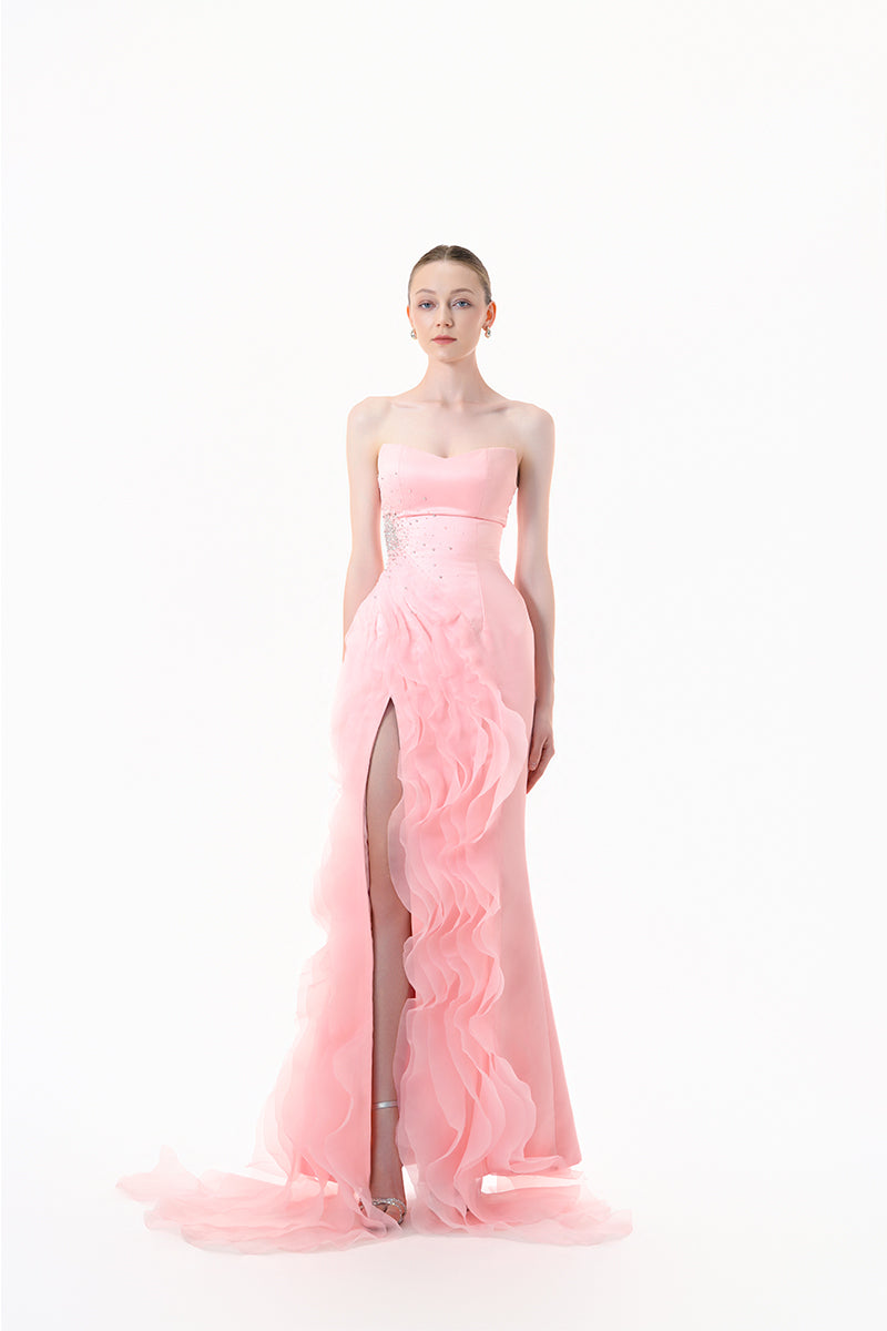 Blush pink strapless ruffle slit gown by Happy Clothing, flowing fabric with elegant ruffle details and a high slit.