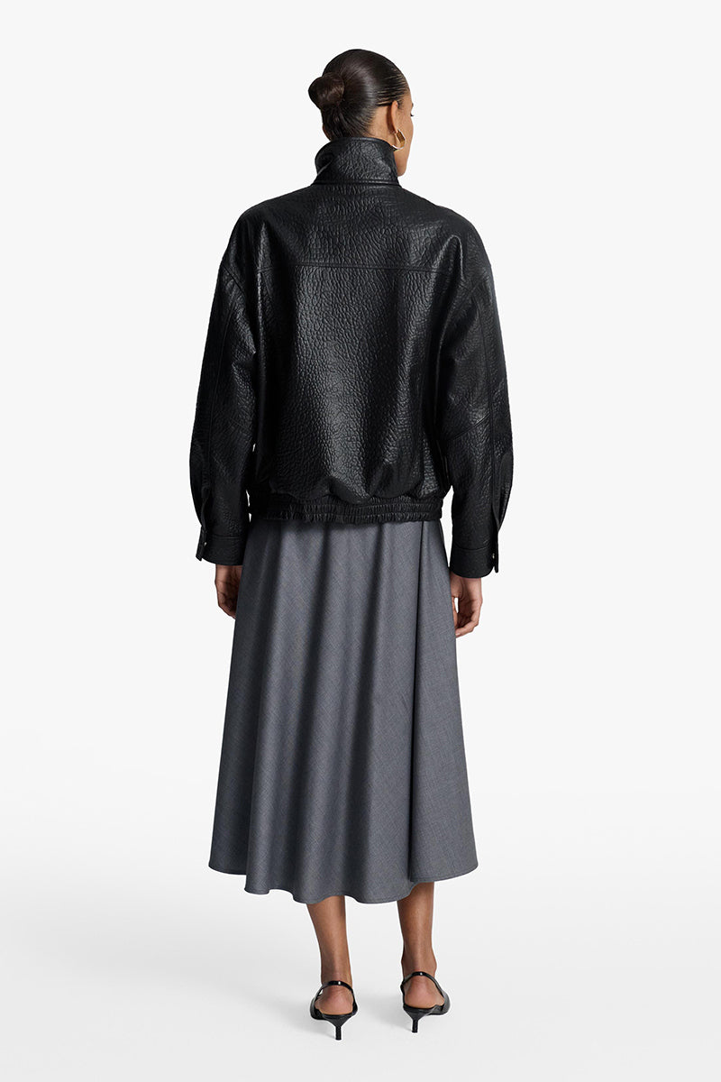 Acaria Studio Zoe leather bomber jacket with ribbed collar, cuffs, and front zipper, shown in black on a model.