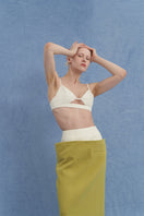 JINSUN ivory tweed appliqué bra top showing detailed fabric texture and fitted design on a model.