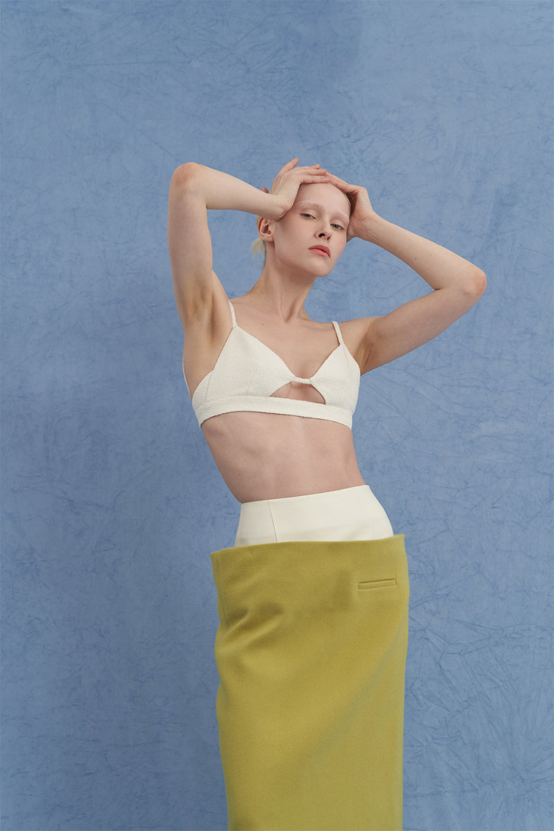 JINSUN ivory tweed appliqué bra top showing detailed fabric texture and fitted design on a model.