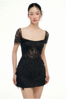 Black lace mini dress by 21Six, featuring a fitted silhouette and delicate lace details, shown on a model.