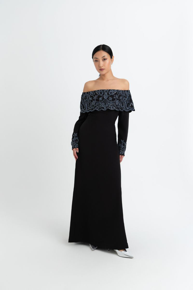 Elegant black gown by Raishma featuring a fitted silhouette and intricate detailing, perfect for formal occasions.