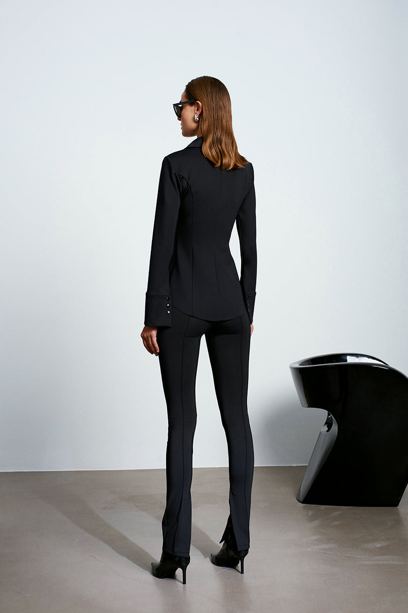 Black Acaria Studio SCUBA shirt featuring a fitted, smooth fabric design, displayed flat on a white background.