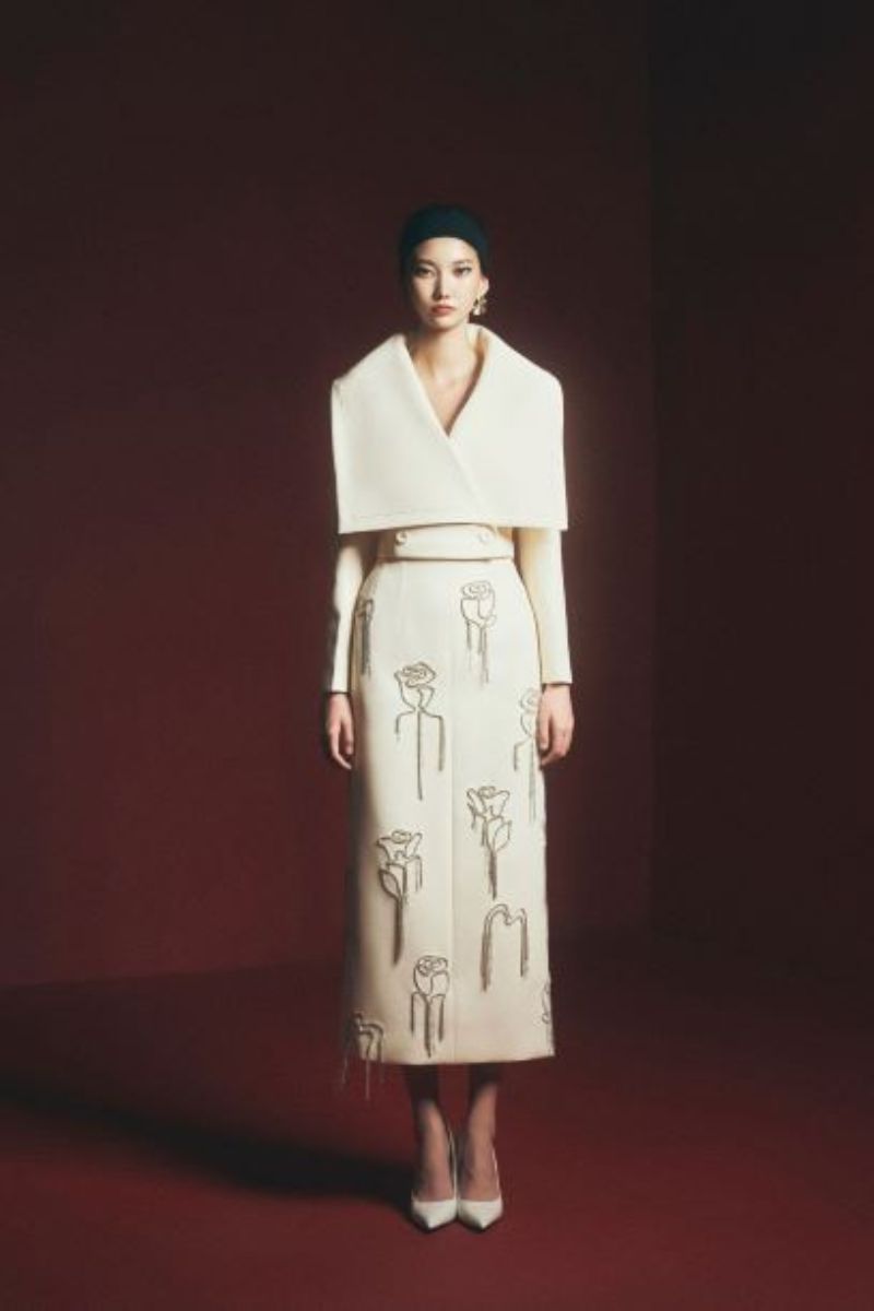 Grayson sheath floral midi skirt by Maison Des Copains, featuring a fitted waist and a flowy, floral-patterned design.
