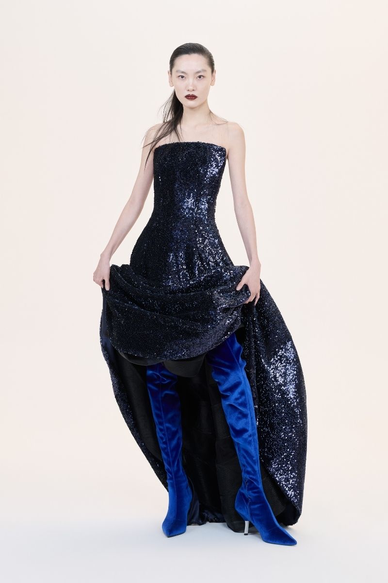 Nihan Peker Vertigo strapless gown in elegant fabric, flowing design with intricate details, perfect for formal events.