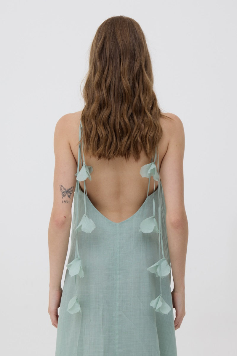Mint green Kontenta Aurora maxi dress featuring a flowing silhouette and elegant design, showcased on a model.