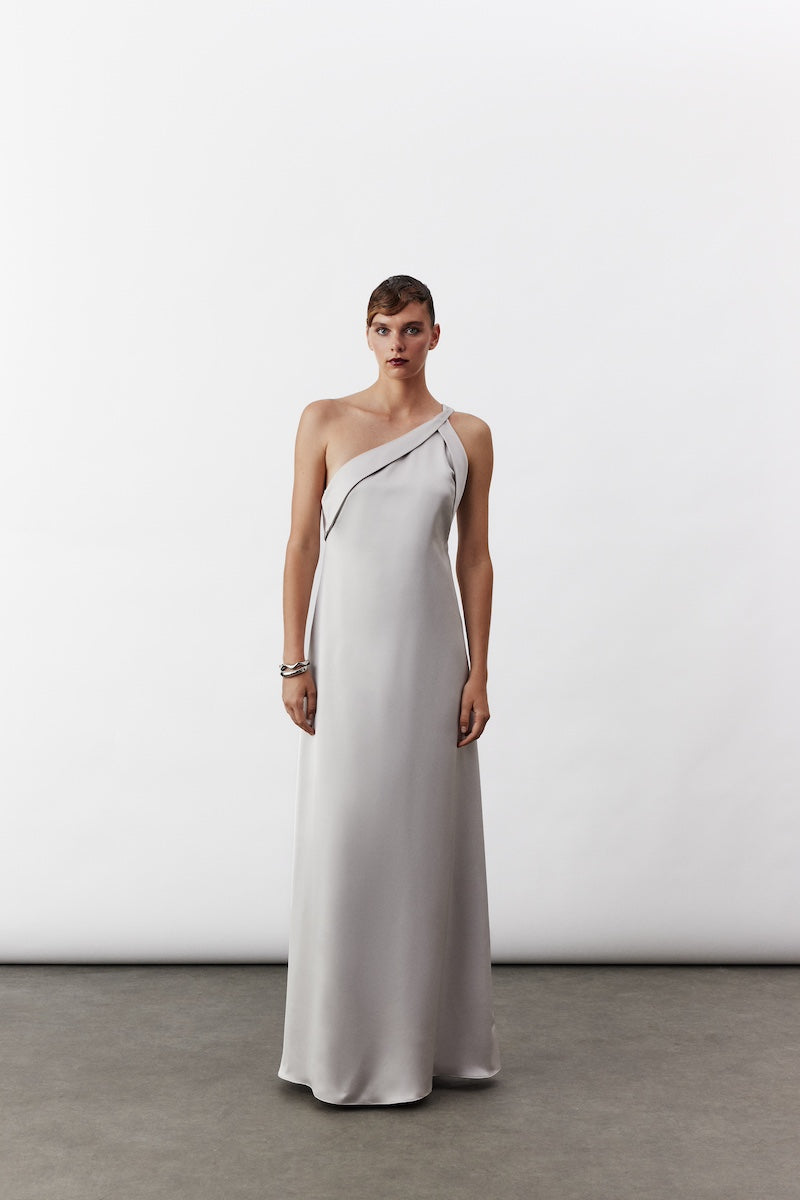 Nazlı Ceren AIMEE long satin silver maxi dress displayed on a model, featuring elegant flowing fabric and a sophisticated design.