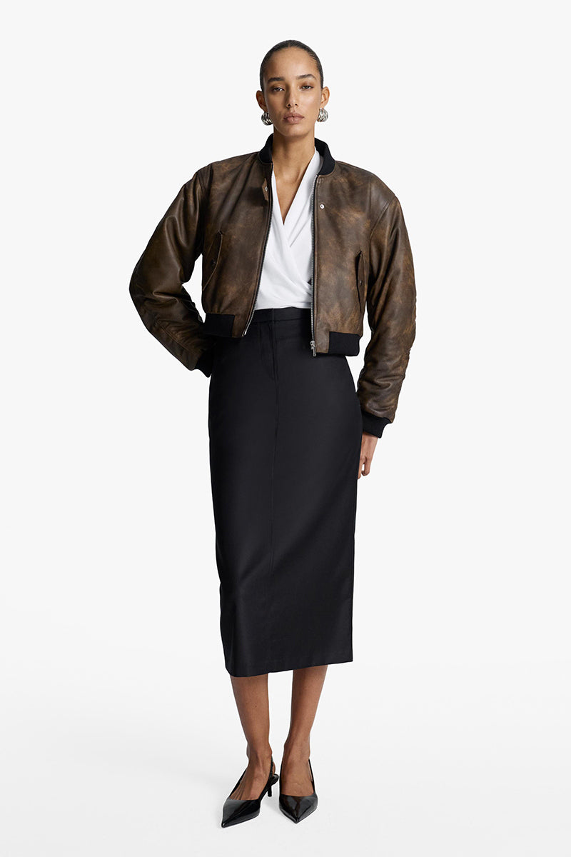 Acaria Studio NOSTALGIE leather bomber jacket, stylish brown leather jacket with classic design and ribbed cuffs, on a hanger.