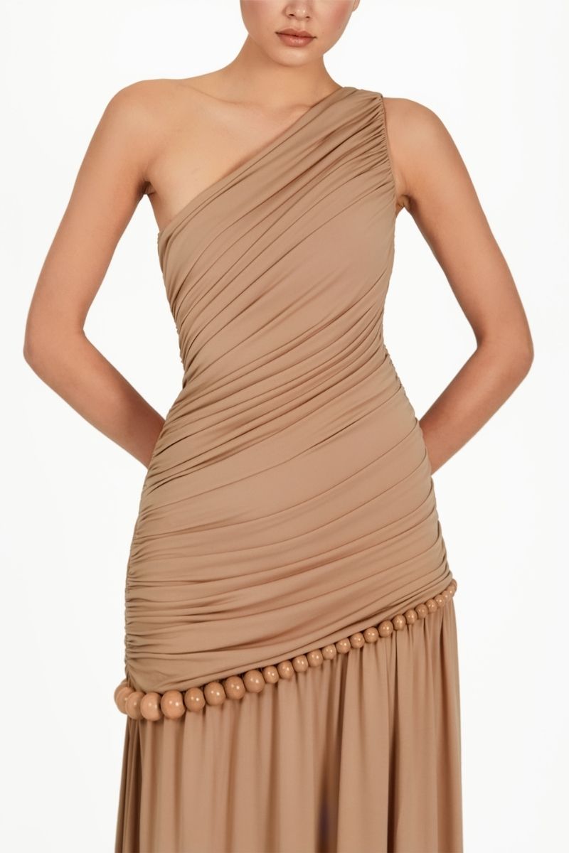 Khanum's KASBA tan maxi dress featuring a flowing silhouette, sleeveless design, and elegant fabric for a stylish look.