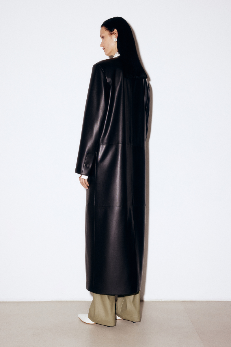 ELENAREVA black faux leather coat with a sleek design, shown on a white background, highlighting the stylish collar and smooth texture.