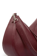 VIKELE STUDIO Denise shoulder bag in burgundy with sleek design and adjustable strap, displayed on a neutral background.