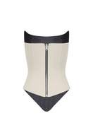 Angled two-sided corset top by BALYKINA featuring a structured design with adjustable straps and a sleek black finish.