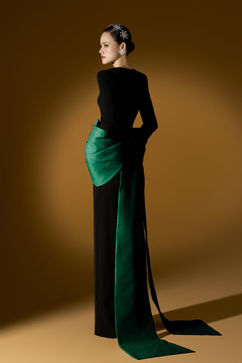Green Loreli crepe and taffeta gown by I.H.F, showcasing elegant fabric and flowing design on a mannequin.