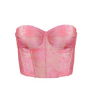 Estefania Idilio pink citrus corset top with structured design and adjustable straps, featuring a vibrant, fruity-inspired pattern.